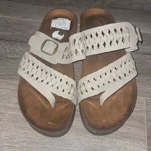 Women’s sandals cliffs by white mountain